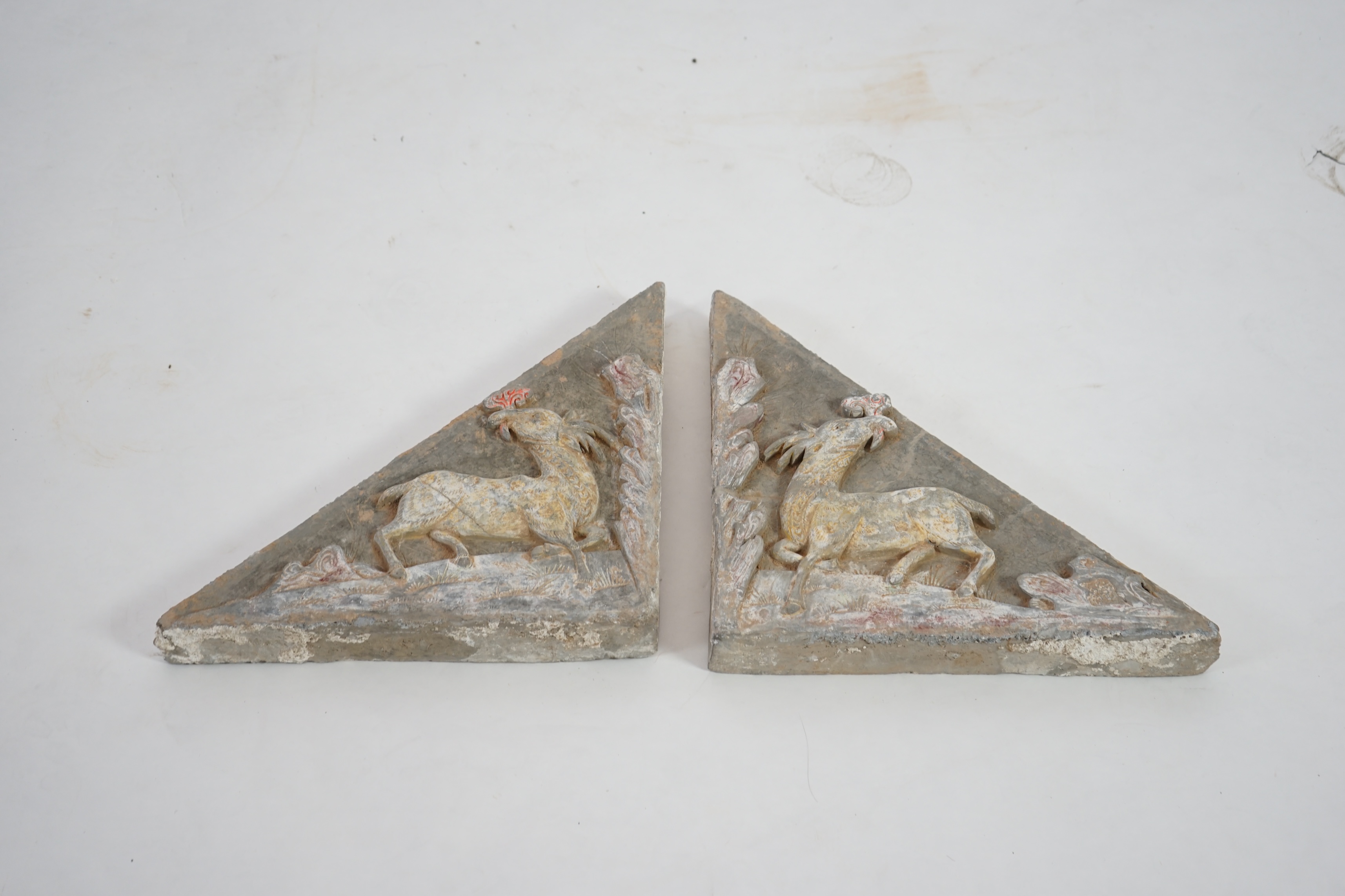 A fine pair of large Chinese painted pottery triangular tiles, Ming Dynasty (1368-1644)